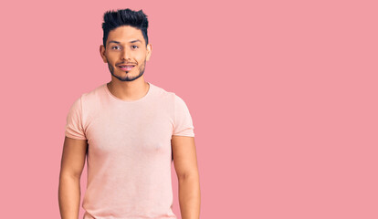 Handsome latin american young man wearing casual clothes looking positive and happy standing and smiling with a confident smile showing teeth