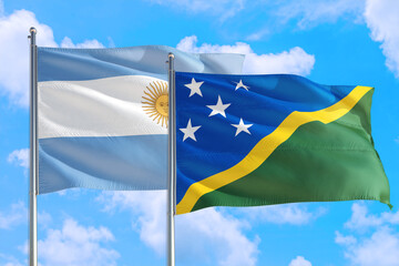 Solomon Islands and Argentina national flag waving in the windy deep blue sky. Diplomacy and international relations concept.