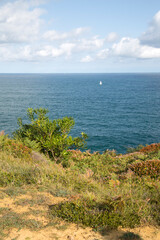Fototapeta na wymiar Sailing Boat from Cliffs in Loredo; Santander