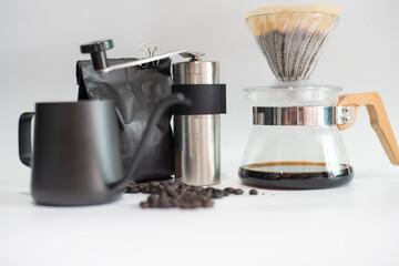 Drip brewing coffee on paper filtered pouring water over roasted with coffee bean