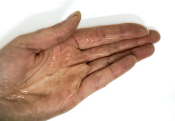 Fototapeta premium hand with wet slime on it. white background