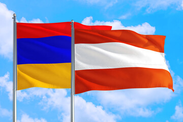 Austria and Armenia national flag waving in the windy deep blue sky. Diplomacy and international relations concept.