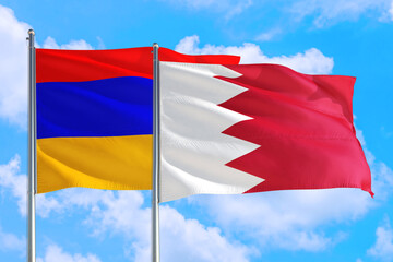 Bahrain and Armenia national flag waving in the windy deep blue sky. Diplomacy and international relations concept.