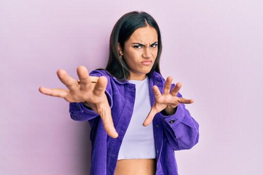 Young brunette woman wearing casual clothes doing stop gesture with hands palms, angry and frustration expression
