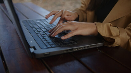Close-up of woman hands searching or typing on laptop keyboard working woman, technology freelance concept