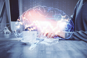 Man with computer background with brain theme hologram. Concept of brainstorm. Double exposure.