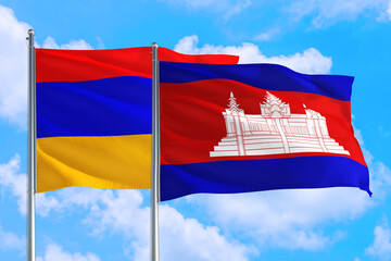 Cambodia and Armenia national flag waving in the windy deep blue sky. Diplomacy and international relations concept.