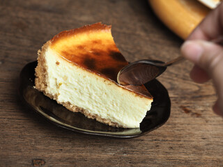 Taking a piece of cheesecake with spoon