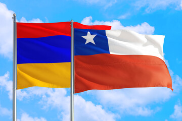 Chile and Armenia national flag waving in the windy deep blue sky. Diplomacy and international relations concept.