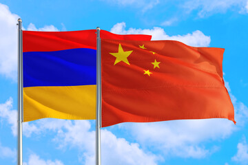 China and Armenia national flag waving in the windy deep blue sky. Diplomacy and international relations concept.