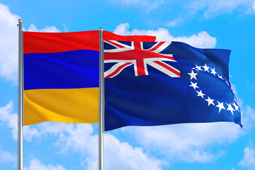 Cook Islands and Armenia national flag waving in the windy deep blue sky. Diplomacy and international relations concept.