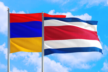 Costa Rica and Armenia national flag waving in the windy deep blue sky. Diplomacy and international relations concept.
