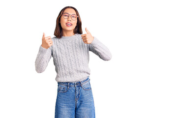 Obraz na płótnie Canvas Young beautiful chinese girl wearing casual clothes success sign doing positive gesture with hand, thumbs up smiling and happy. cheerful expression and winner gesture.