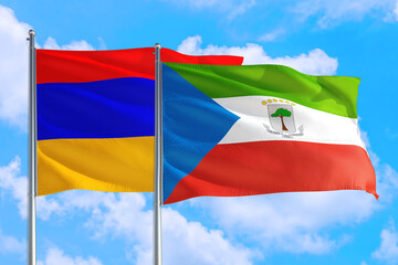 Equatorial Guinea and Armenia national flag waving in the windy deep blue sky. Diplomacy and international relations concept.