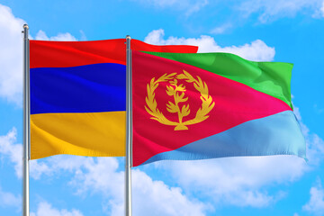 Eritrea and Armenia national flag waving in the windy deep blue sky. Diplomacy and international relations concept.