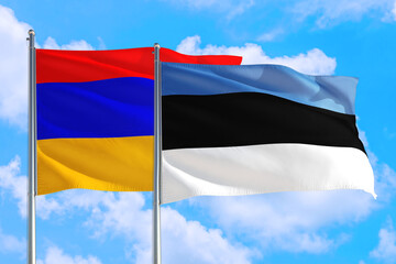 Estonia and Armenia national flag waving in the windy deep blue sky. Diplomacy and international relations concept.