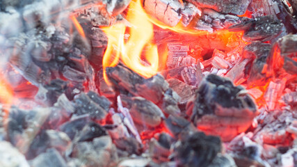 burning bright red coals of the fire. fire. texture. poster.