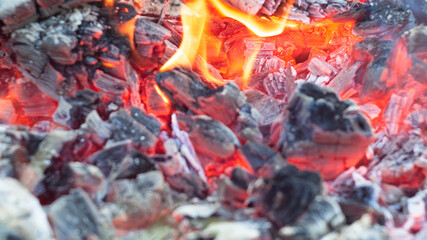 burning bright red coals of the fire. fire. texture. poster.