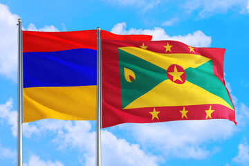 Grenada and Armenia national flag waving in the windy deep blue sky. Diplomacy and international relations concept.