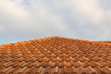 Close up of brown clay roof tiles. Red old dirty roof. Old roof tiles. Construction equipment build a house.