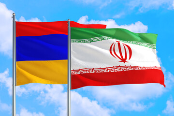 Naklejka na ściany i meble Iran and Armenia national flag waving in the windy deep blue sky. Diplomacy and international relations concept.