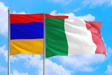 Italy and Armenia national flag waving in the windy deep blue sky. Diplomacy and international relations concept.