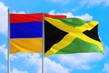 Jamaica and Armenia national flag waving in the windy deep blue sky. Diplomacy and international relations concept.