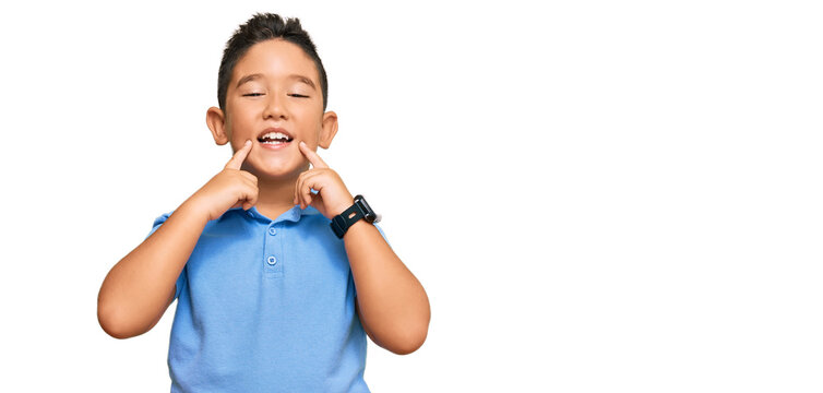 Little Boy Hispanic Kid Wearing Casual Clothes Smiling With Open Mouth, Fingers Pointing And Forcing Cheerful Smile