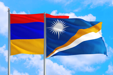 Marshall Islands and Armenia national flag waving in the windy deep blue sky. Diplomacy and international relations concept.