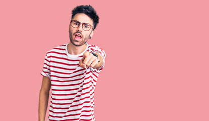 Young hispanic man wearing casual clothes pointing displeased and frustrated to the camera, angry and furious with you