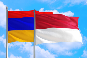 Monaco and Armenia national flag waving in the windy deep blue sky. Diplomacy and international relations concept.