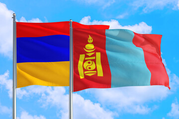 Mongolia and Armenia national flag waving in the windy deep blue sky. Diplomacy and international relations concept.