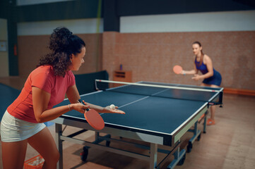 Women play ping pong match, table tennis