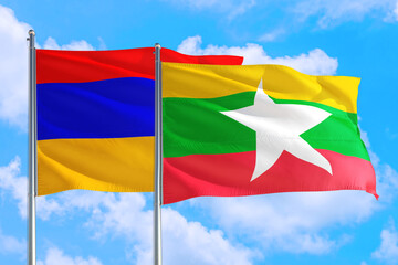 Myanmar and Armenia national flag waving in the windy deep blue sky. Diplomacy and international relations concept.