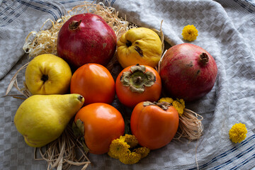 ripe whole pomegranates quince and persimmon lie together on the table