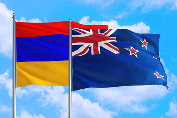 New Zealand and Armenia national flag waving in the windy deep blue sky. Diplomacy and international relations concept.