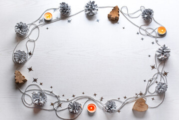 oval frame made of silver cones beads stars and candles