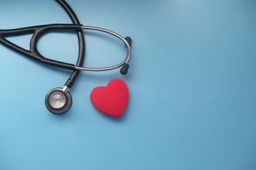 heart shape symbol and stethoscope on blue background 