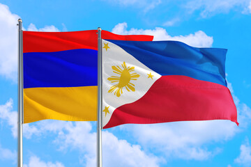 Fototapeta na wymiar Philippines and Armenia national flag waving in the windy deep blue sky. Diplomacy and international relations concept.