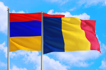 Romania and Armenia national flag waving in the windy deep blue sky. Diplomacy and international relations concept.