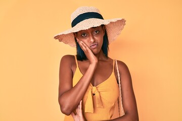 Young african american woman wearing summer hat thinking looking tired and bored with depression problems with crossed arms.