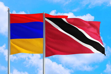 Trinidad And Tobago and Armenia national flag waving in the windy deep blue sky. Diplomacy and international relations concept.