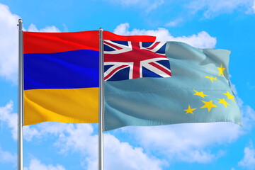 Tuvalu and Armenia national flag waving in the windy deep blue sky. Diplomacy and international...