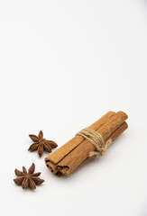 Cinnamon sticks and star anise on a white background.