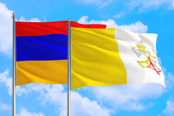 Vatican City and Armenia national flag waving in the windy deep blue sky. Diplomacy and international relations concept.