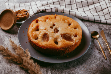 Homemade pear cake, on a tempo gray background.