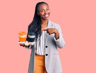 Young african american woman wearing business clothes holding take away cup of coffee smiling happy pointing with hand and finger