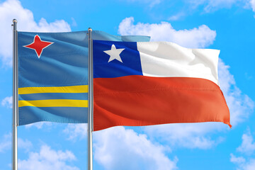 Chile and Aruba national flag waving in the windy deep blue sky. Diplomacy and international relations concept.