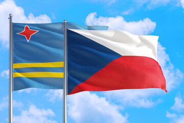 Czech Republic and Aruba national flag waving in the windy deep blue sky. Diplomacy and international relations concept.