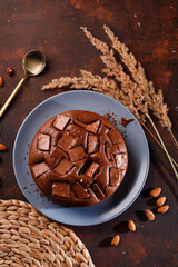 Chocolate cake with chocolate pieces on a brown background